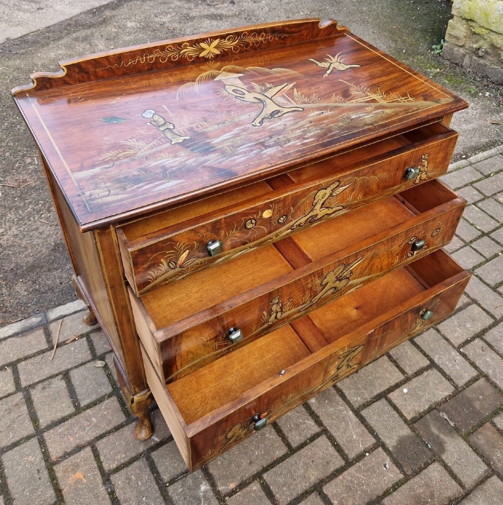 A four-piece Edwardian walnut bedroom suite featuring hand-painted Chinoiserie motifs, comprising a bedstead, wardrobe, dressing table, and chest of drawers with cabriole legs. View IX