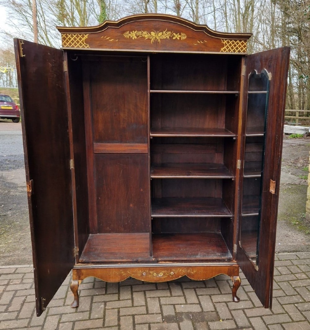 A four-piece Edwardian walnut bedroom suite featuring hand-painted Chinoiserie motifs, comprising a bedstead, wardrobe, dressing table, and chest of drawers with cabriole legs. View XII