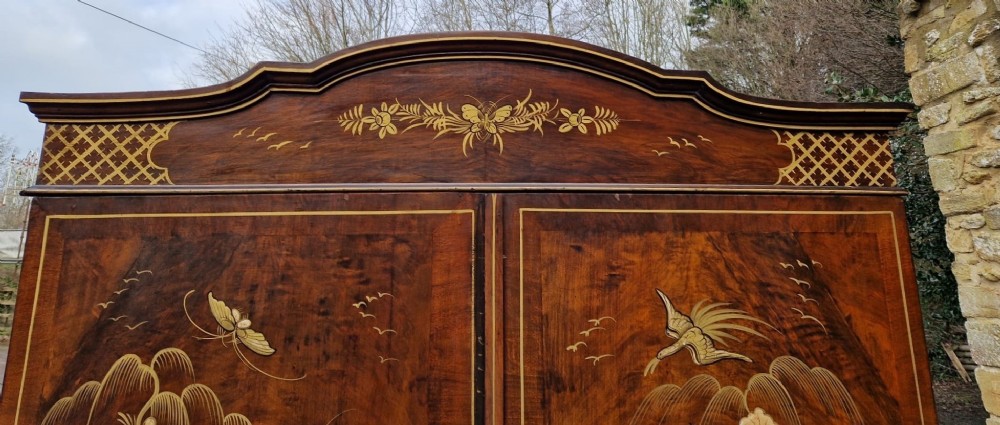 A four-piece Edwardian walnut bedroom suite featuring hand-painted Chinoiserie motifs, comprising a bedstead, wardrobe, dressing table, and chest of drawers with cabriole legs. View XIII