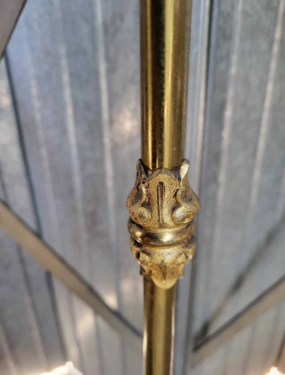 A Victorian brass small double bedstead featuring vertical spindles, decorative brass finials, side rails, and ceramic castors. View IV