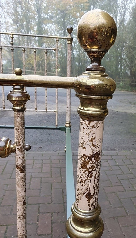 A Victorian brass and painted iron bedstead featuring turned vertical spindles, brass top rails, and spherical brass finials. View VI