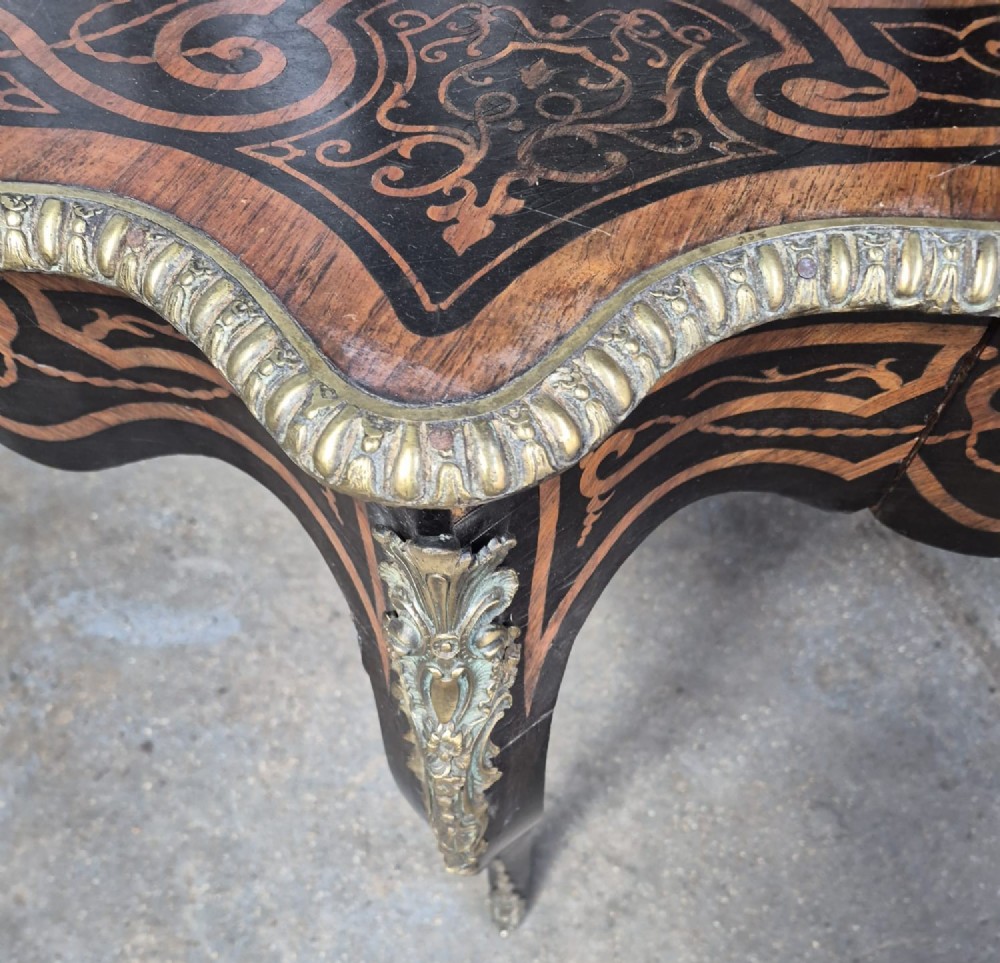 A 19th-century French kingwood centre table featuring a shaped serpentine top with geometric parquetry inlay, scroll marquetry borders, ormolu mounts, and cabriole legs. View IV