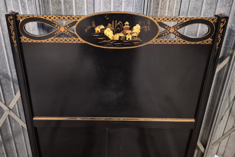 An Edwardian black lacquered single bedstead decorated with gold Chinoiserie scenes and floral motifs on the headboard and footboard. View II