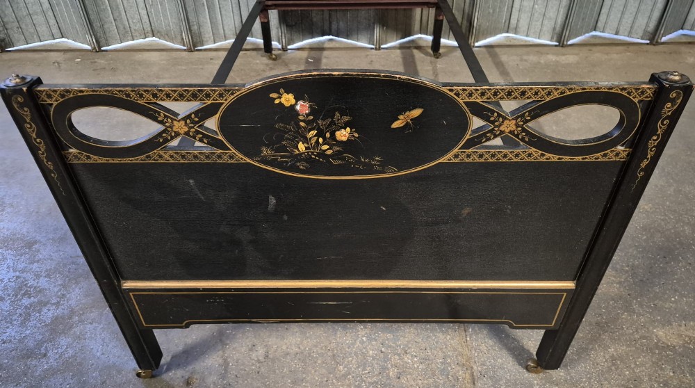 An Edwardian black lacquered single bedstead decorated with gold Chinoiserie scenes and floral motifs on the headboard and footboard. View III