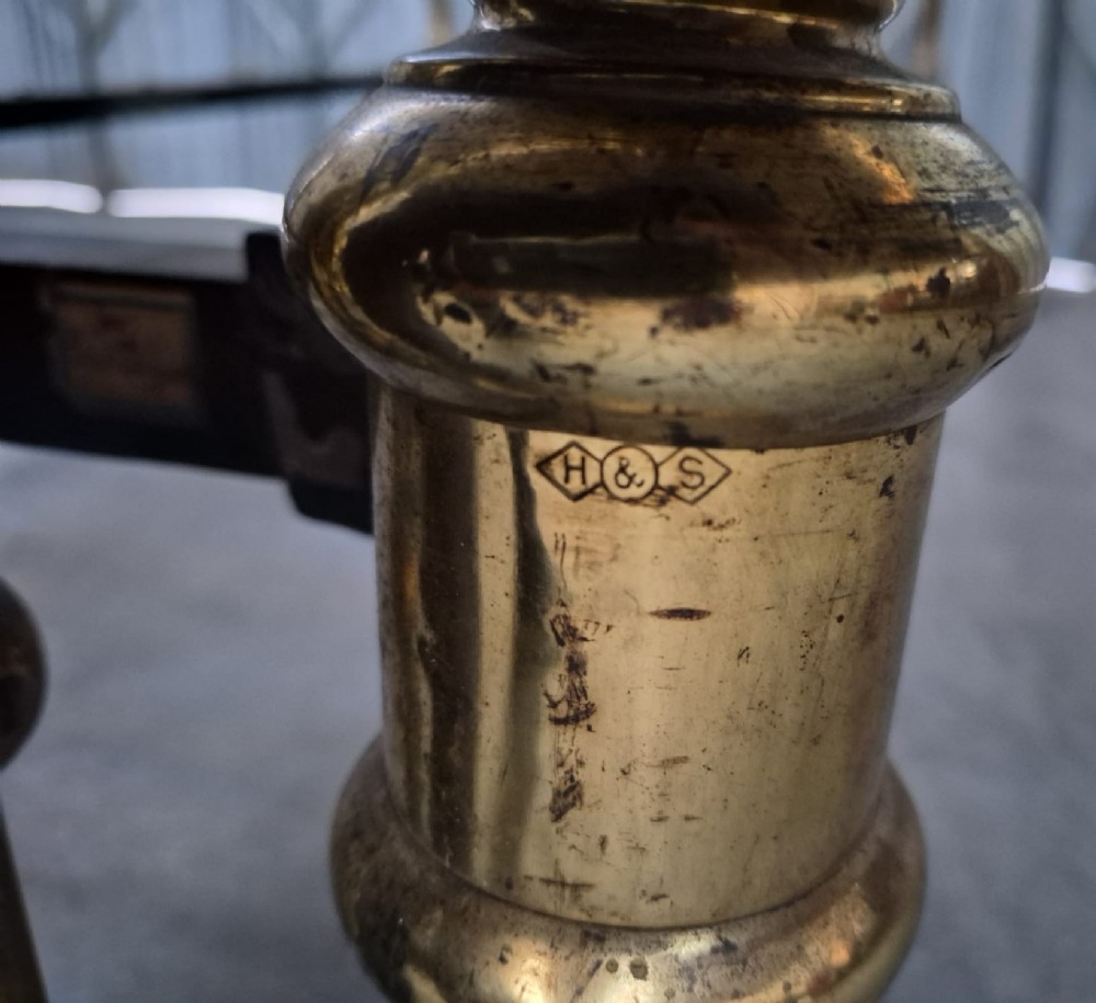 A pair of matching Victorian brass single bedsteads featuring vertical tubular spindles, ball finials, and castors. View IV