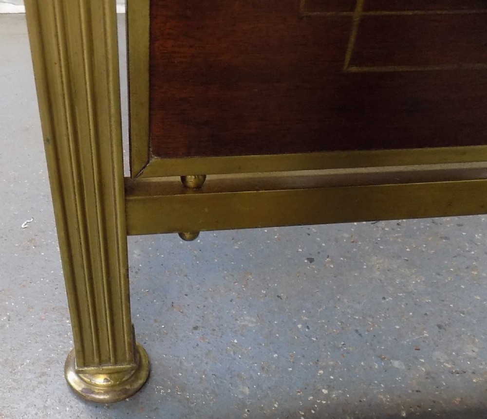 A pair of late Victorian brass-framed twin bedsteads featuring polished brass rails, top drapery swags, urn finials, and central mahogany timber panels with decorative brass plaques. View VIII