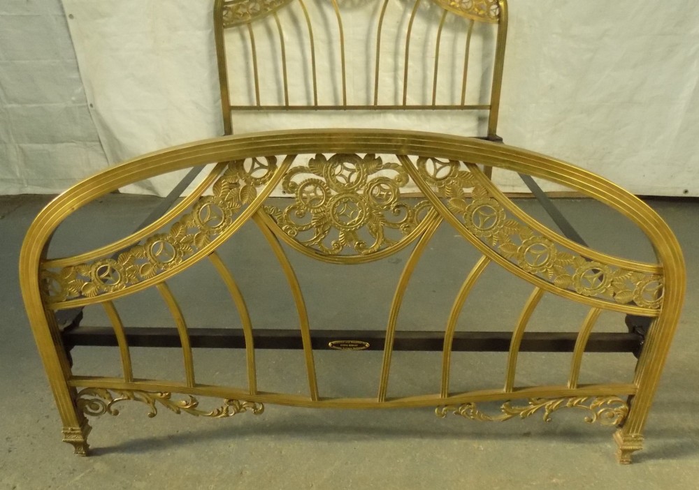 A late 19th-century brass bedstead with an arched headboard and footboard featuring detailed scrollwork and vertical spindles. View III