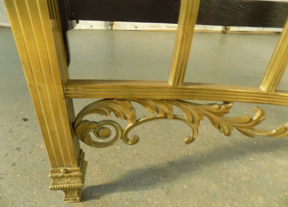 A late 19th-century brass bedstead with an arched headboard and footboard featuring detailed scrollwork and vertical spindles. View VII