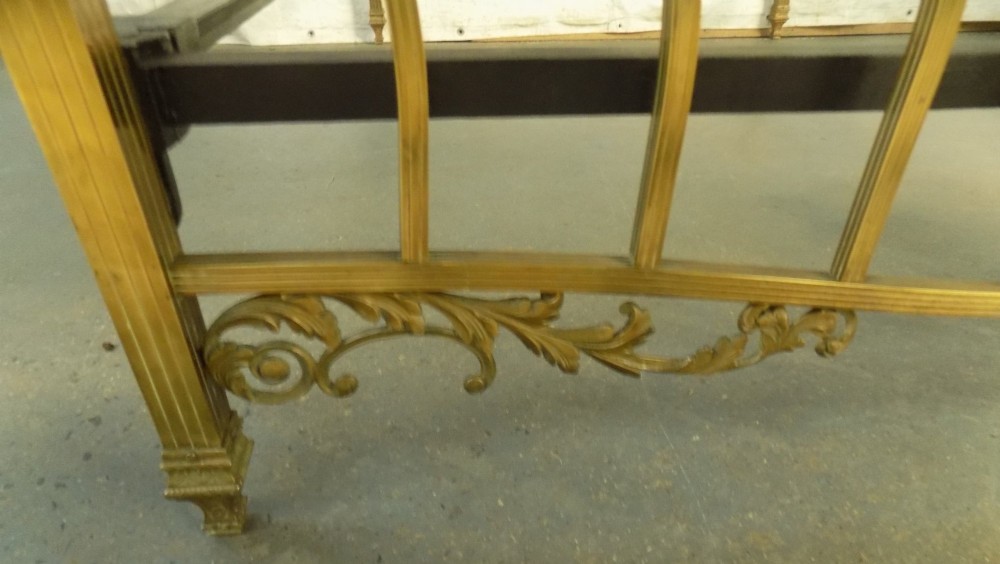 A late 19th-century brass bedstead with an arched headboard and footboard featuring detailed scrollwork and vertical spindles. View VIII
