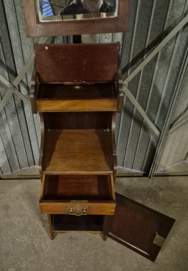 A Victorian dark mahogany shaving stand featuring an adjustable rectangular top mirror on a central column, a spindle gallery, an open recess, a single drawer, and a lower cupboard. View II