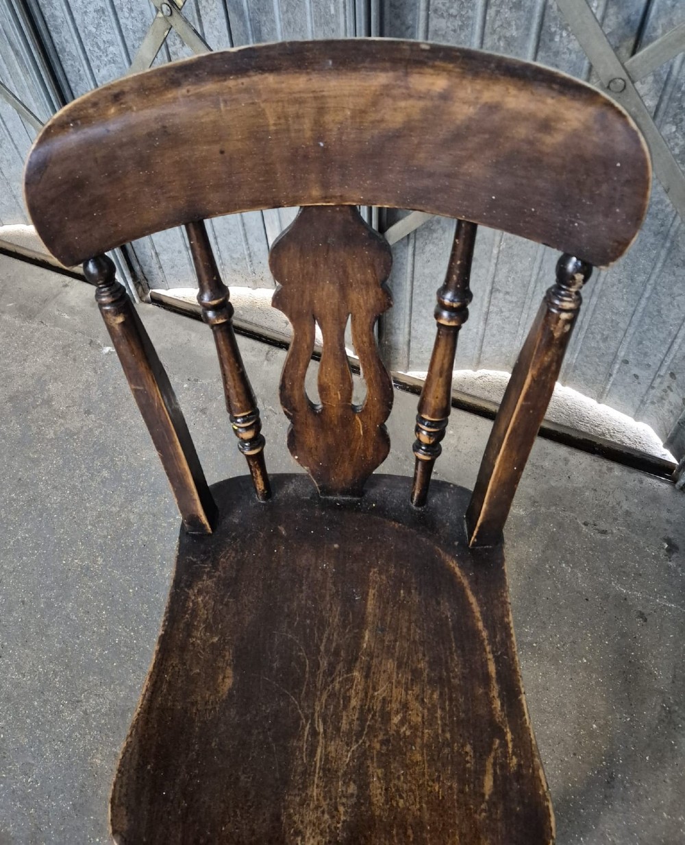 A pair of Victorian Thames Valley elm kitchen chairs with dark timber finish, turned legs, solid contoured seats, and pierced central back splats. View III