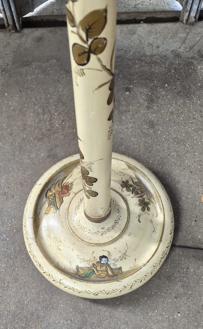 An Edwardian chinoiserie standard lamp with a cream painted turned column shaft featuring hand-painted gold oriental figures and landscapes, ending in a circular base. View II