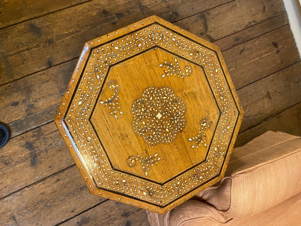 A 19th-century octagonal warm brown wood side table featuring Moorish arch carved legs and geometric mother-of-pearl inlay across the top and aprons. View II