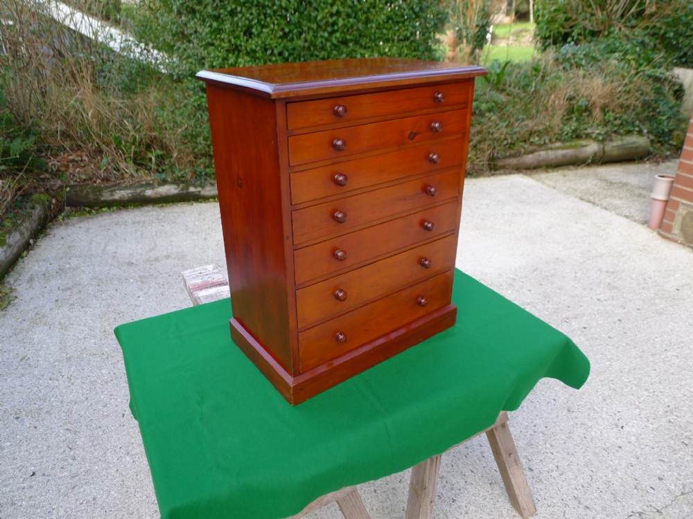 A 7 DRAWER VICTORIAN DEAL COLLECTORS CABINET BY HARRODS OF LONDON. CIRCA 1890