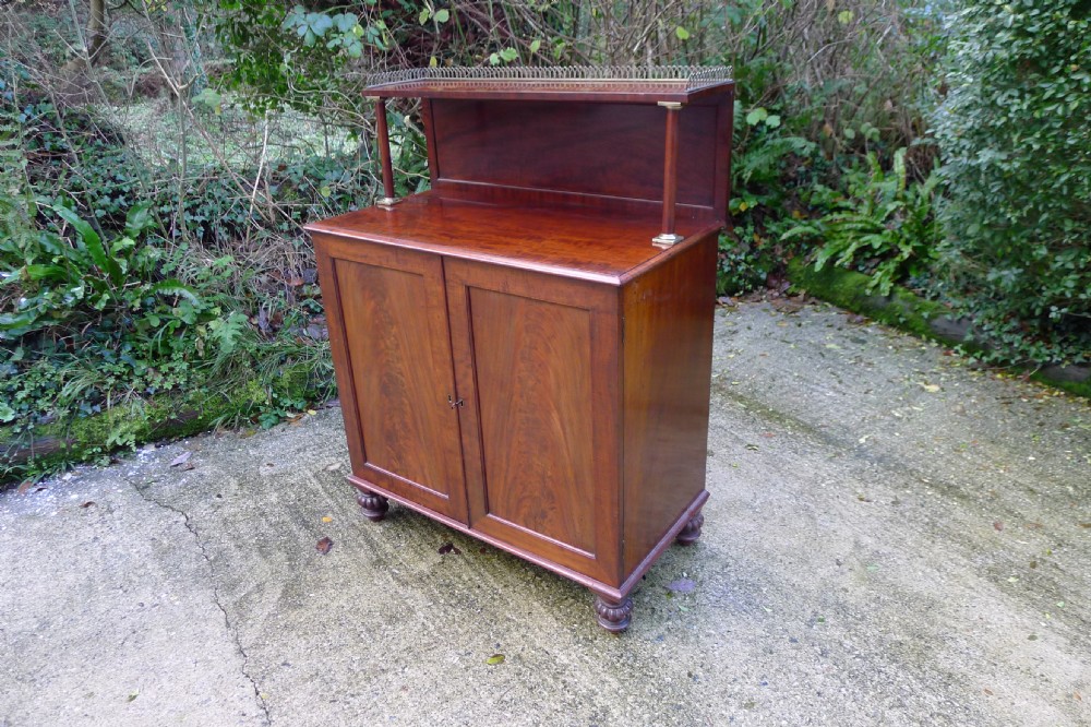 Victorian flame mahogany collectors cabinet featuring an upper shelf with a brass gallery and double doors opening to reveal multiple shallow drawers. View VIII