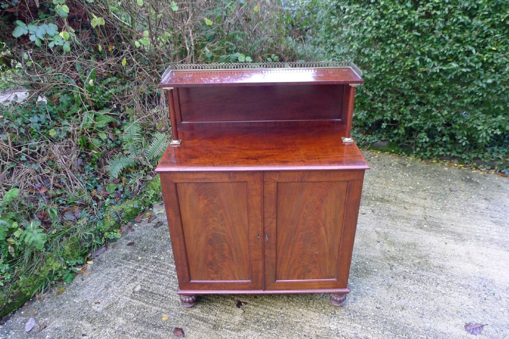 Victorian flame mahogany collectors cabinet featuring an upper shelf with a brass gallery and double doors opening to reveal multiple shallow drawers. View IX