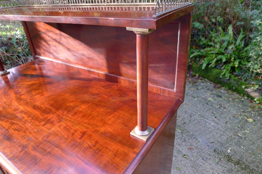Victorian flame mahogany collectors cabinet featuring an upper shelf with a brass gallery and double doors opening to reveal multiple shallow drawers. View XIX