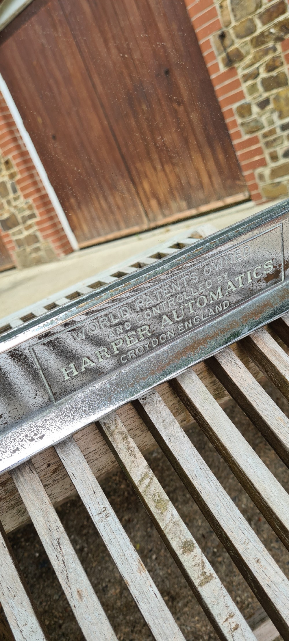 A rectangular 1930s chrome advertising mirror with black lettered signage for cigarettes and matches by Harper Automatics. View V