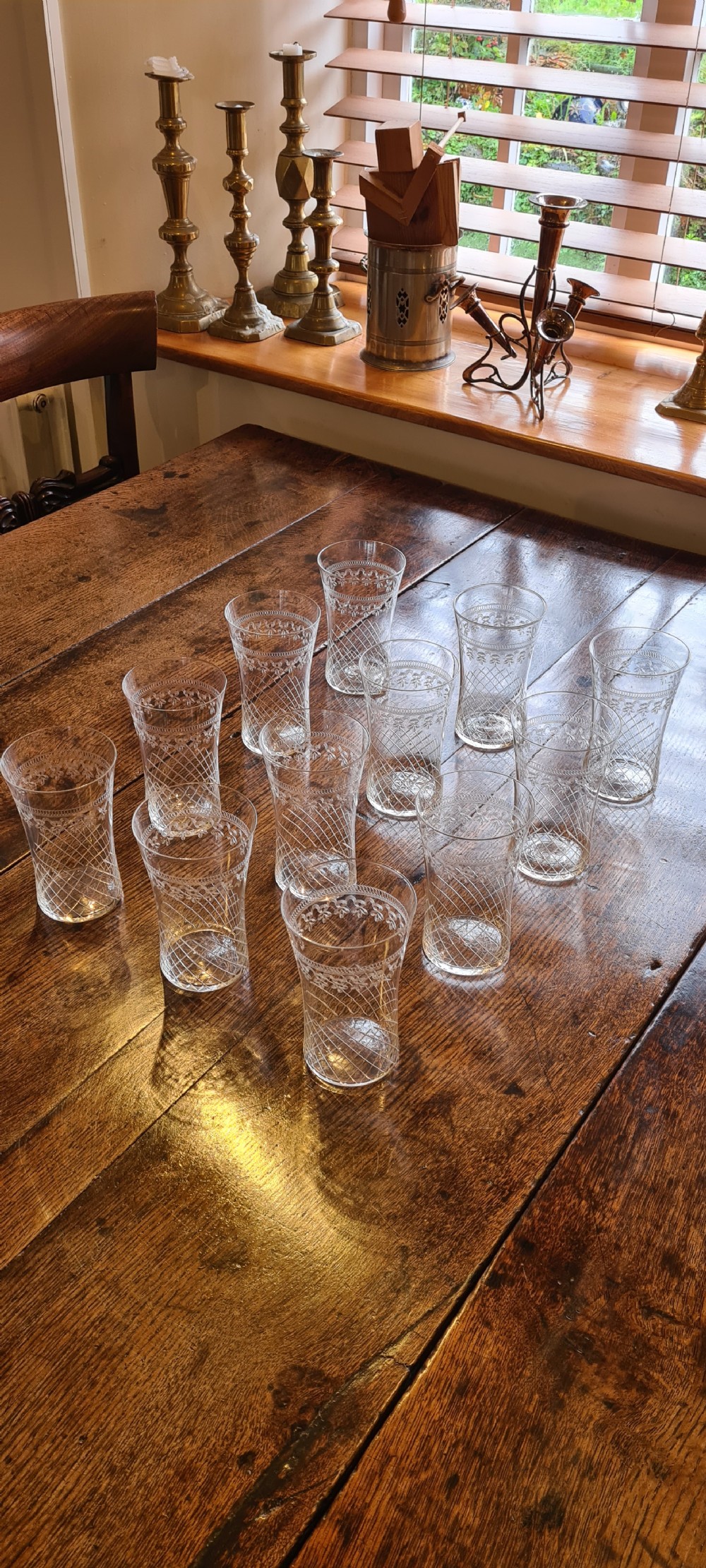 A twelve-piece set of clear Edwardian glass cordial tumblers with etched lattice and foliate bands. View III
