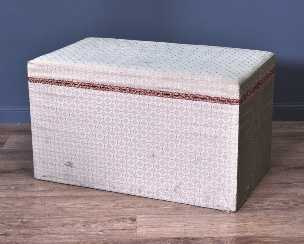 A rectangular Victorian blanket box upholstered in cream lattice-patterned fabric featuring terracotta braid trim around the lid edge. View XI