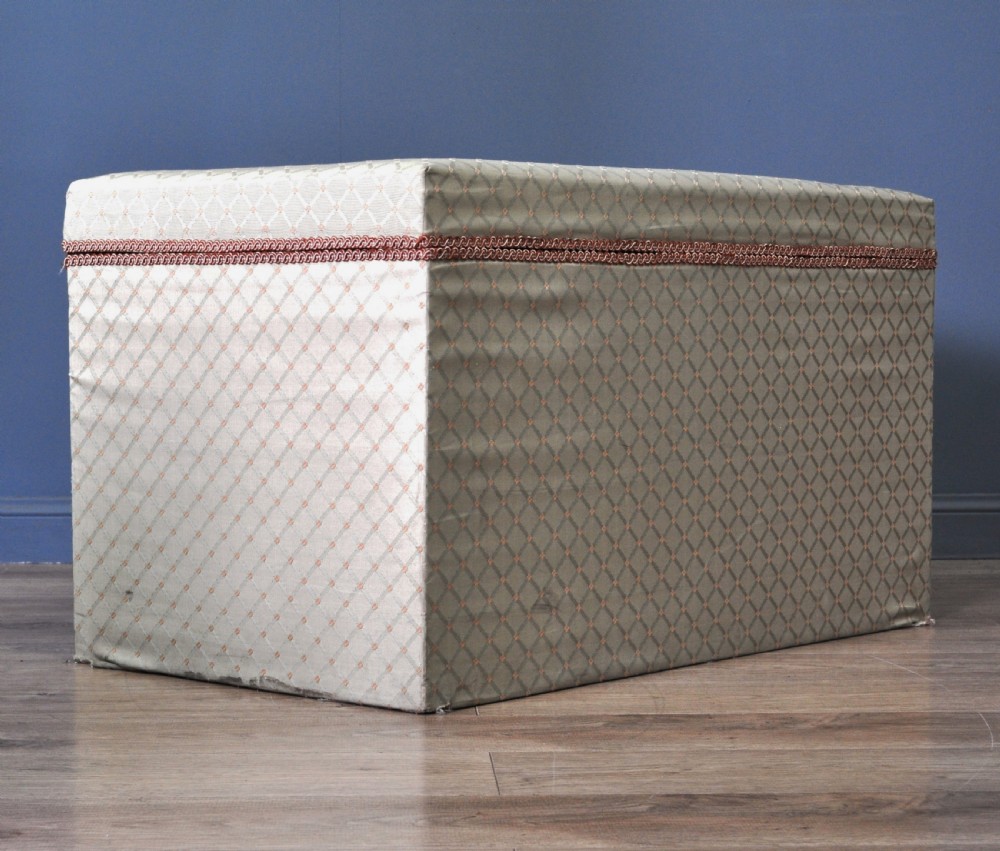 A rectangular Victorian blanket box upholstered in cream lattice-patterned fabric featuring terracotta braid trim around the lid edge. View XIII