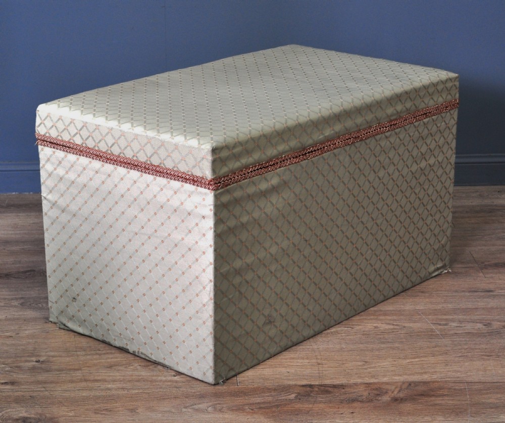 A rectangular Victorian blanket box upholstered in cream lattice-patterned fabric featuring terracotta braid trim around the lid edge. View XVI