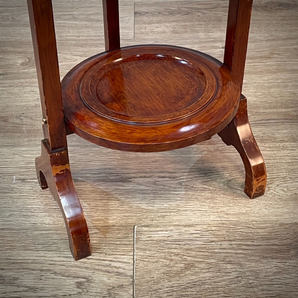 An antique three-tier folding mahogany cake stand with circular platforms, a top carrying handle, and splayed feet. View VII