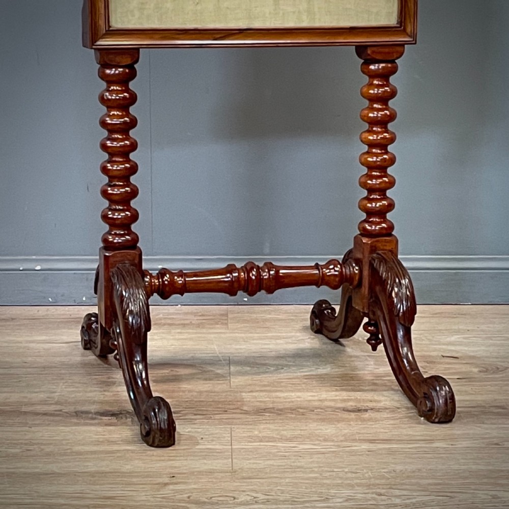 A Victorian mahogany fire screen featuring bobbin-turned uprights, carved feet, and a framed needlework panel displaying a floral bouquet. View III
