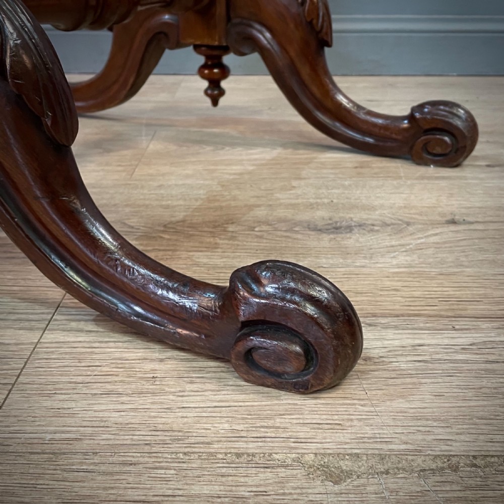 A Victorian mahogany fire screen featuring bobbin-turned uprights, carved feet, and a framed needlework panel displaying a floral bouquet. View VIII