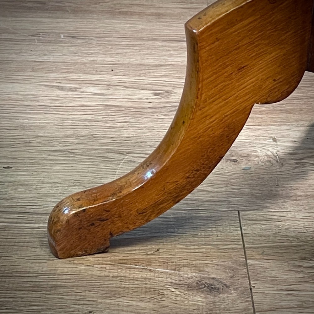 A Victorian circular satin birch occasional table featuring a turned central column supported by a tripod base with splayed legs. View III