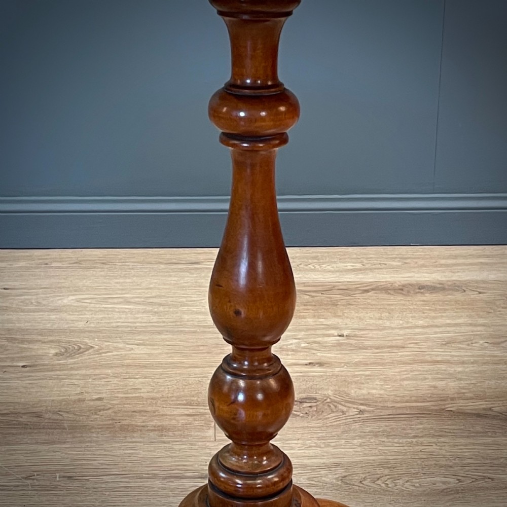 A Victorian circular satin birch occasional table featuring a turned central column supported by a tripod base with splayed legs. View IV