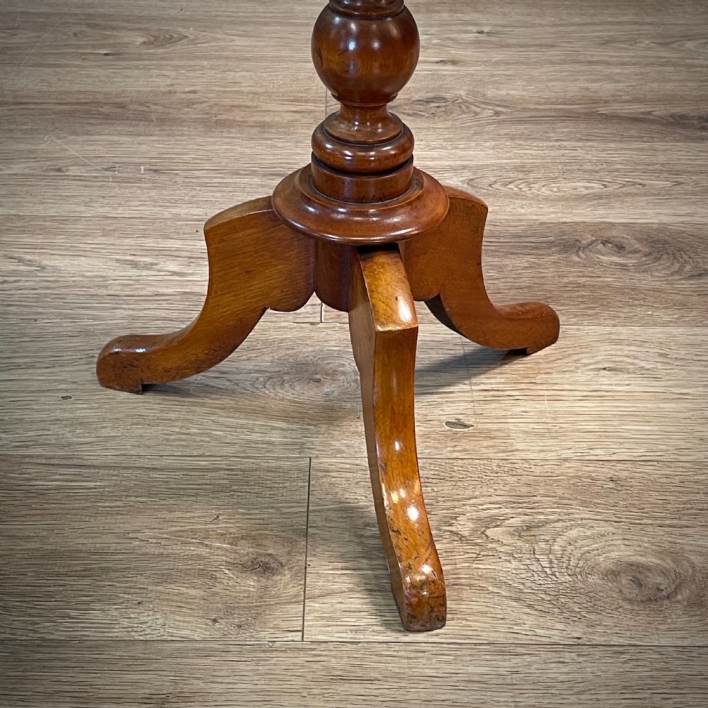 A Victorian circular satin birch occasional table featuring a turned central column supported by a tripod base with splayed legs. View V