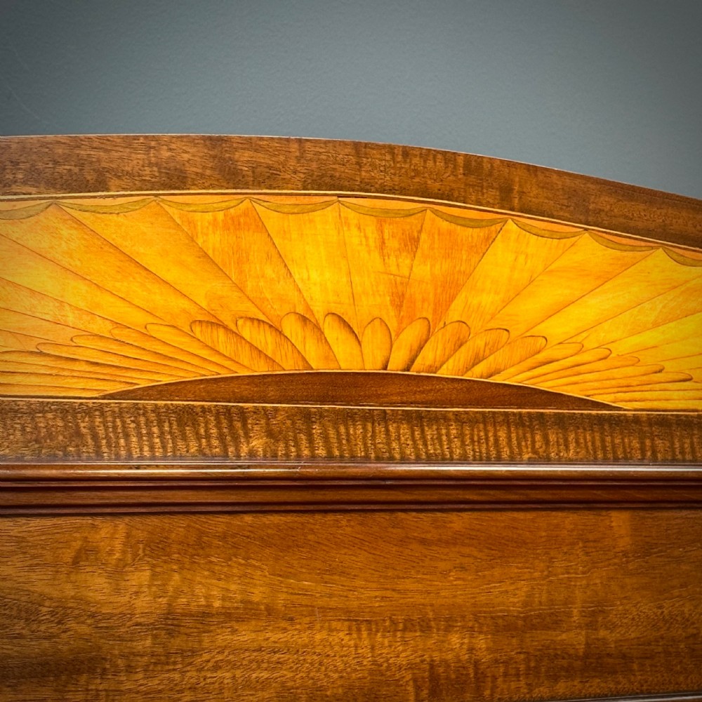An Edwardian bow-fronted mahogany display cabinet featuring a central glazed door flanked by satinwood oval patera marquetry panels and an arched pediment. View XI