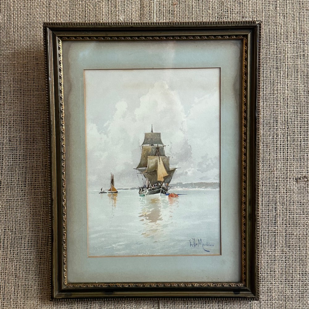 A pair of antique framed maritime prints featuring sailing vessels on calm waters framed in dark wooden moulding with gilt trim. View II