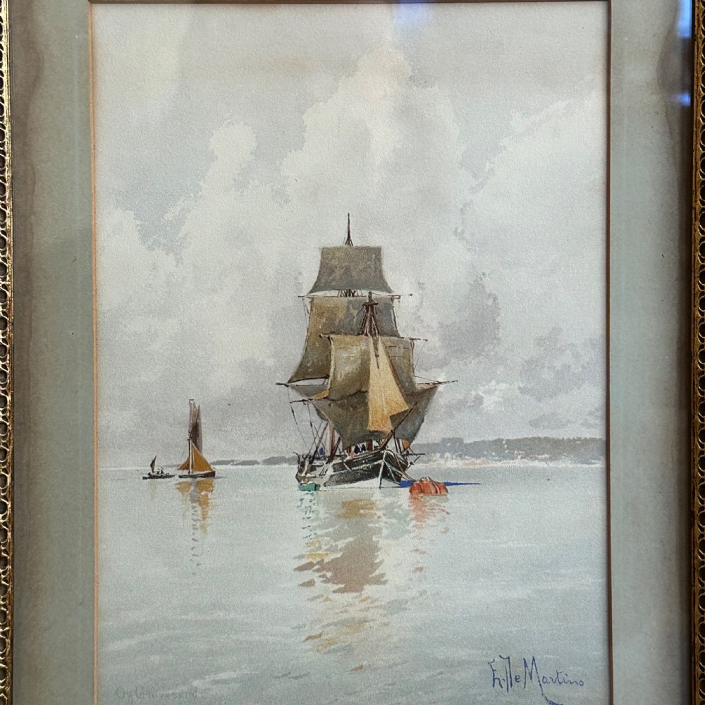 A pair of antique framed maritime prints featuring sailing vessels on calm waters framed in dark wooden moulding with gilt trim. View IV