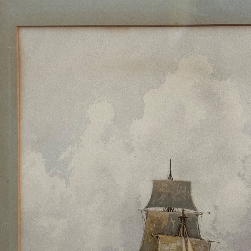 A pair of antique framed maritime prints featuring sailing vessels on calm waters framed in dark wooden moulding with gilt trim. View V