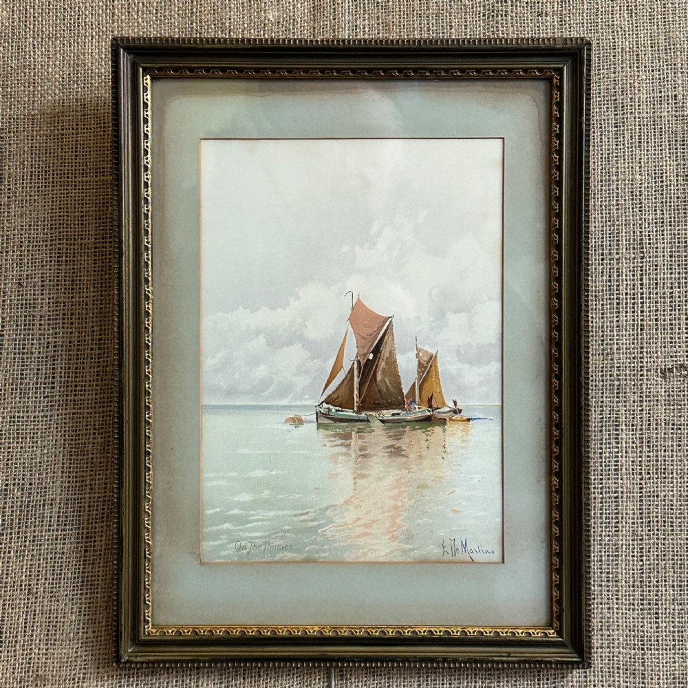 A pair of antique framed maritime prints featuring sailing vessels on calm waters framed in dark wooden moulding with gilt trim. View XI