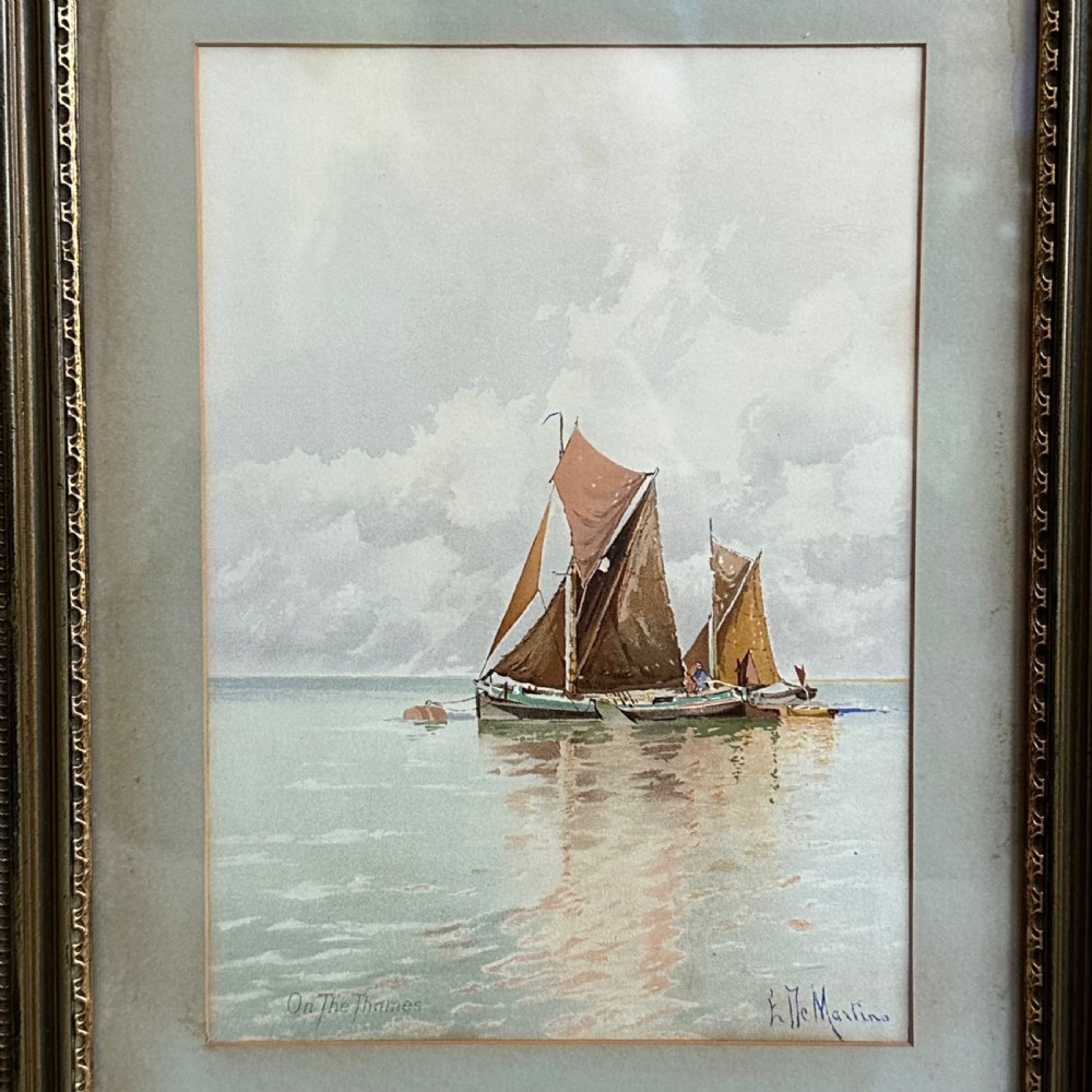 A pair of antique framed maritime prints featuring sailing vessels on calm waters framed in dark wooden moulding with gilt trim. View XII