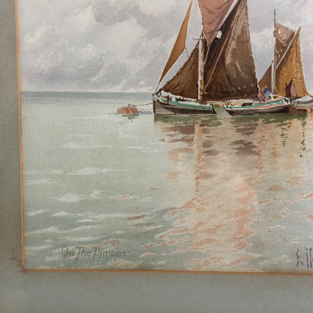 A pair of antique framed maritime prints featuring sailing vessels on calm waters framed in dark wooden moulding with gilt trim. View XIV