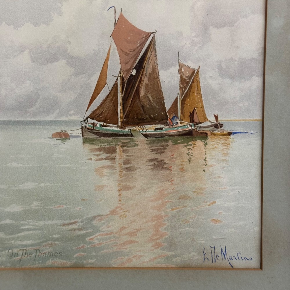 A pair of antique framed maritime prints featuring sailing vessels on calm waters framed in dark wooden moulding with gilt trim. View XV