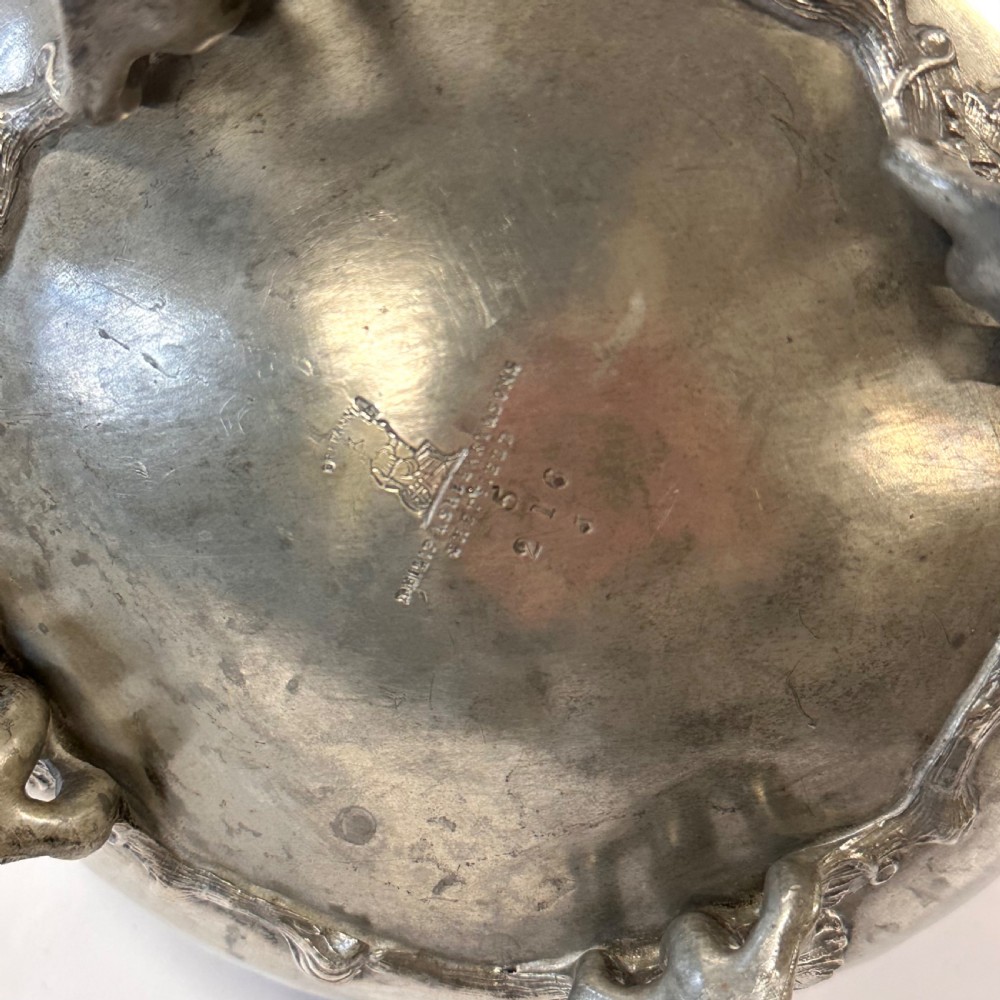 Victorian pewter teapot with a lobed body, curved spout, scrolled feet, and a bud-shaped lid finial. View VII