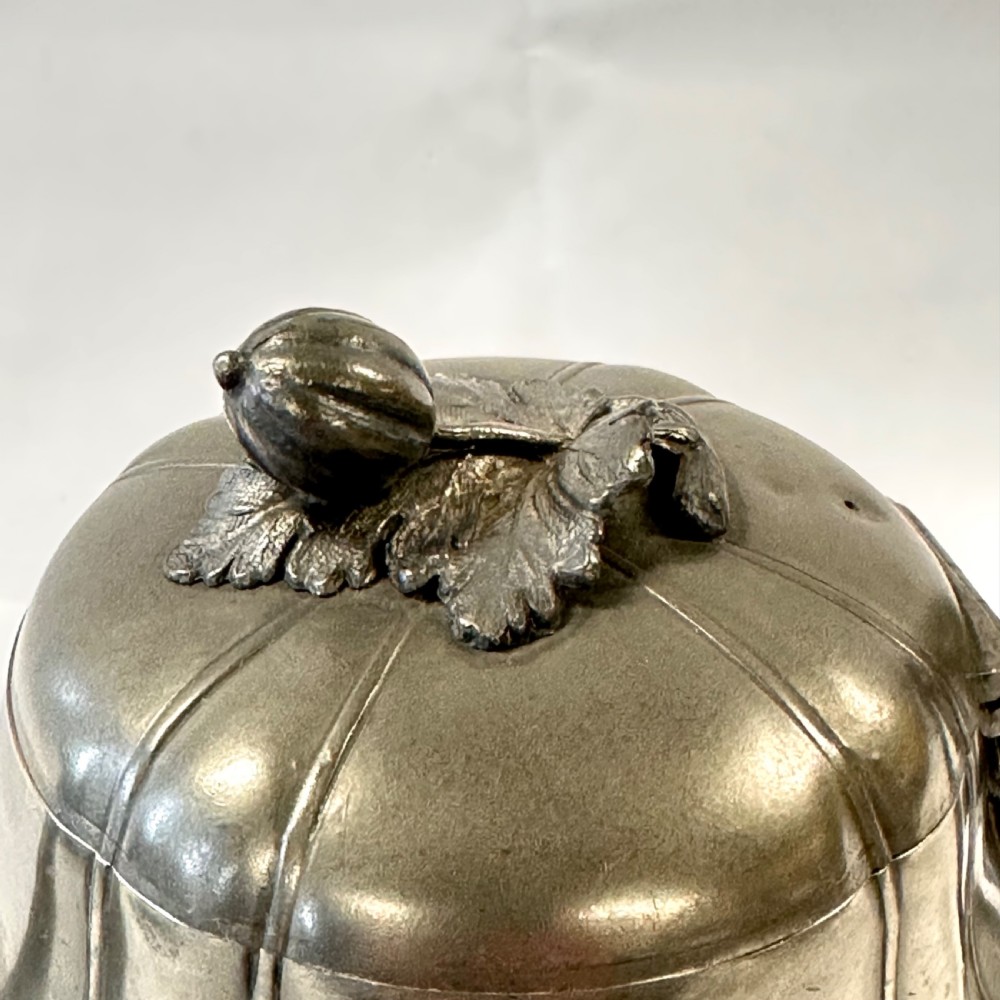 Victorian pewter teapot with a lobed body, curved spout, scrolled feet, and a bud-shaped lid finial. View XII