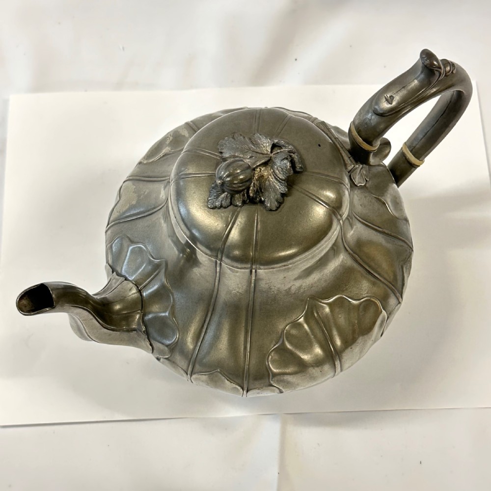 Victorian pewter teapot with a lobed body, curved spout, scrolled feet, and a bud-shaped lid finial. View XIII