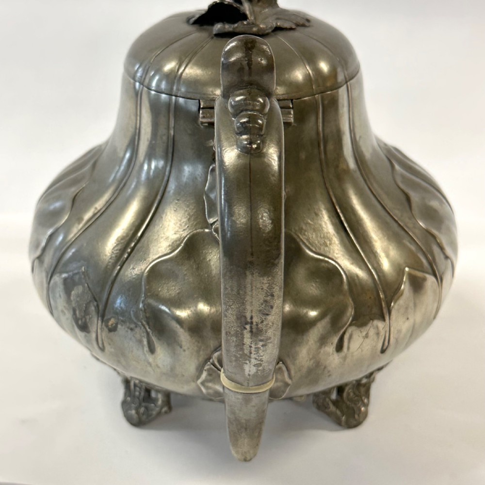 Victorian pewter teapot with a lobed body, curved spout, scrolled feet, and a bud-shaped lid finial. View XIV