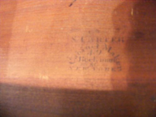fig 4. A miniature Regency mahogany chest of four drawers featuring flame mahogany veneer drawer fronts, turned wooden knobs, brass keyholes, and short turned feet.