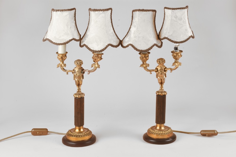 Good pair of gilt bronze cherub lamps
