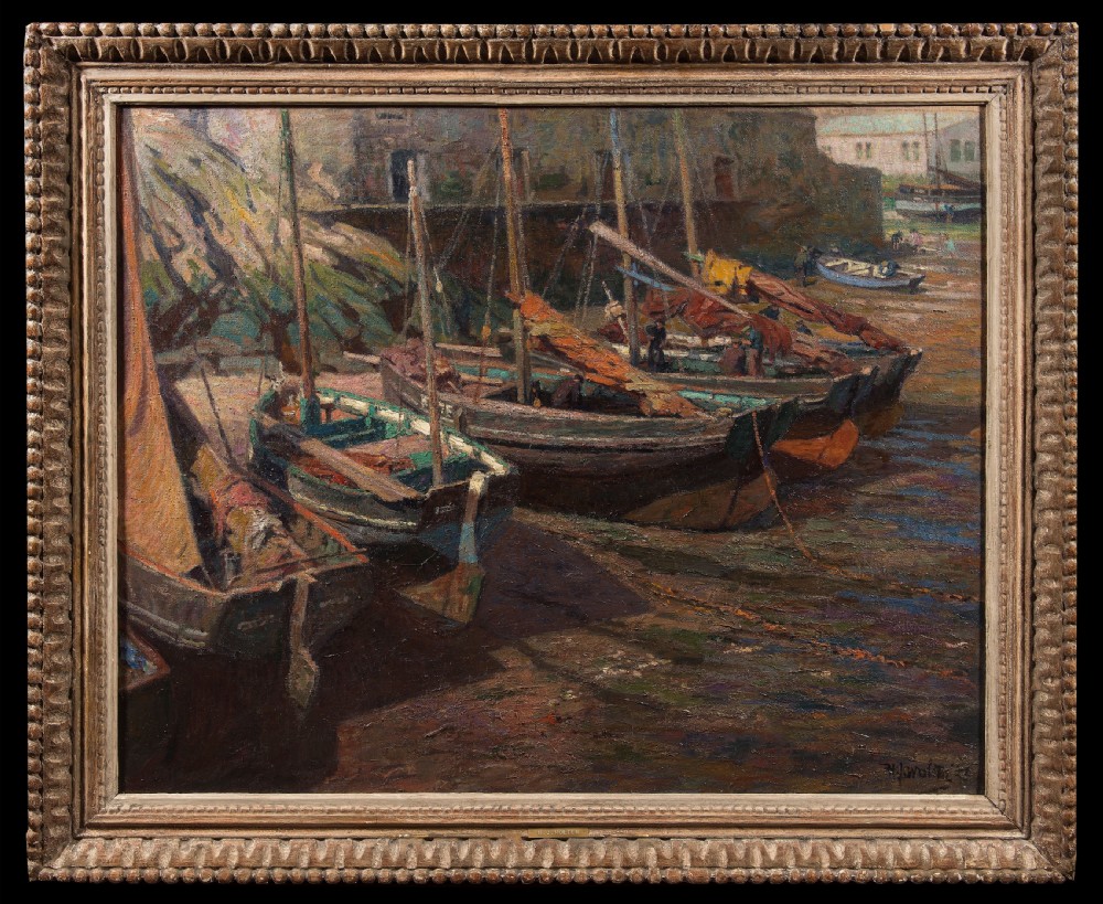 An early 20th-century impressionist oil painting depicting fishing boats docked in Polperro Harbour, set within a carved timber frame.