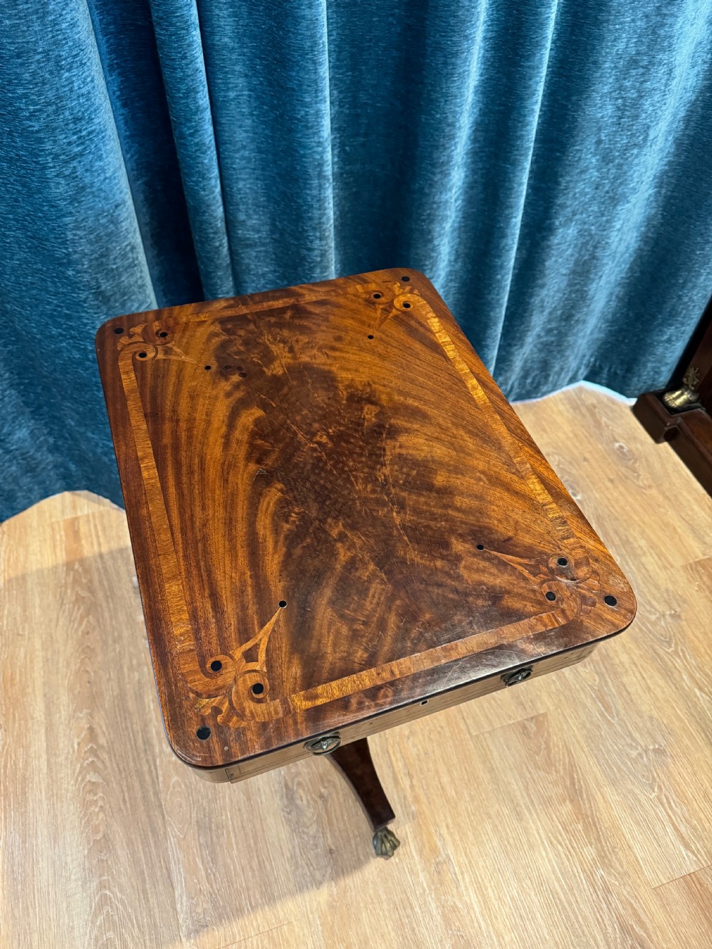 A Regency mahogany occasional table featuring a rectangular inlaid top above a single drawer, supported by a spiral-turned pedestal and a triform base on brass claw feet. View II