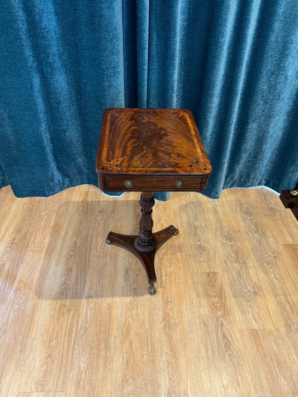 A Regency mahogany occasional table featuring a rectangular inlaid top above a single drawer, supported by a spiral-turned pedestal and a triform base on brass claw feet. View III