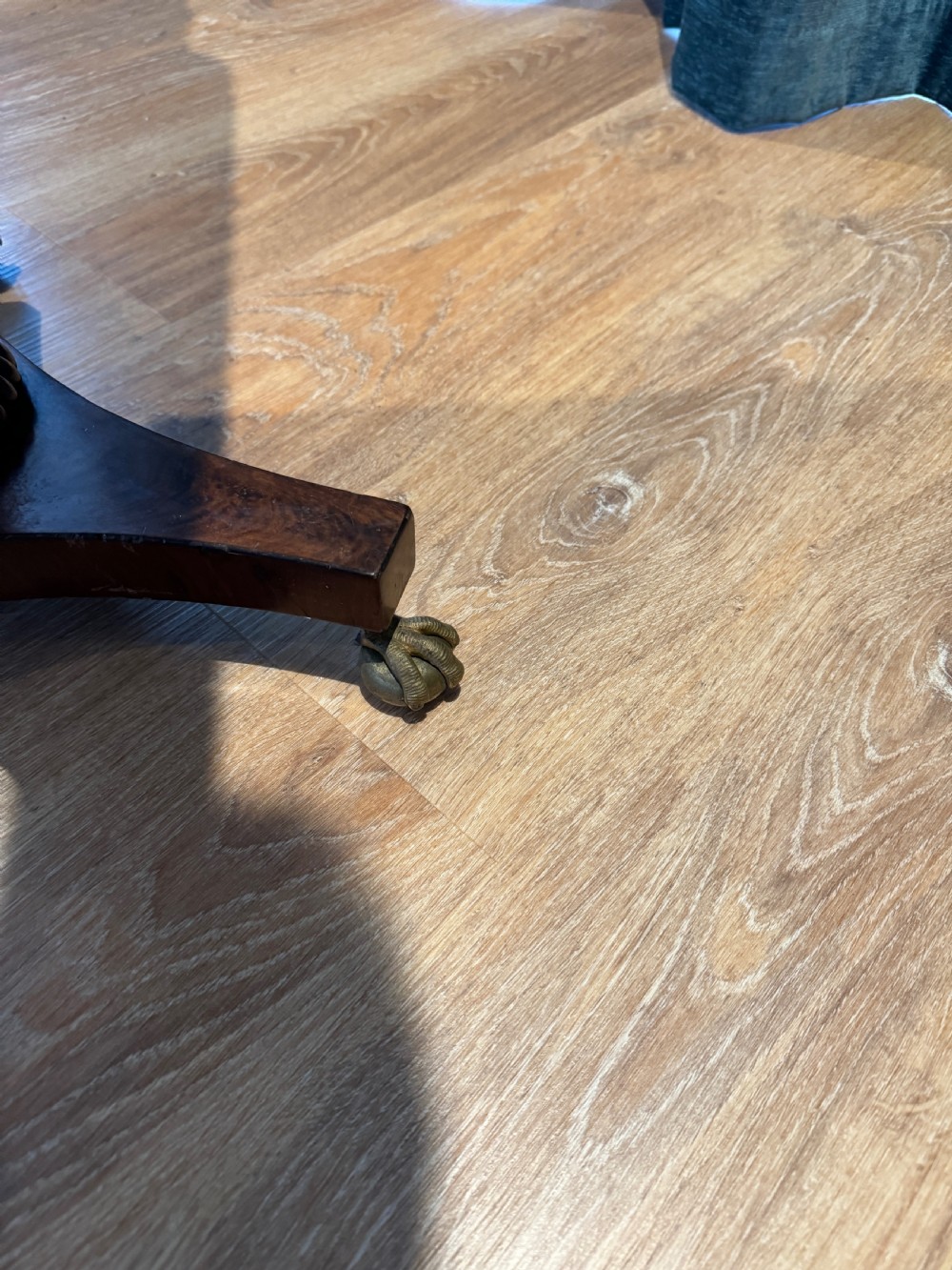 A Regency mahogany occasional table featuring a rectangular inlaid top above a single drawer, supported by a spiral-turned pedestal and a triform base on brass claw feet. View VI